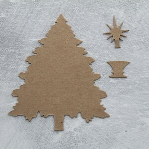 May include: A brown cardboard cutout of a Christmas tree with a star and a vase.