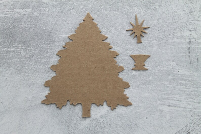 May include: A brown cardboard cutout of a Christmas tree with a star and a vase.