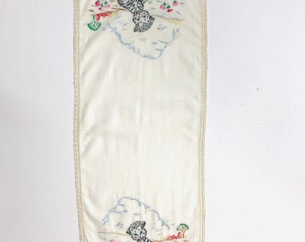 Antique primitive linen table runner with hand stitched puppies playing in a pond and crochet border