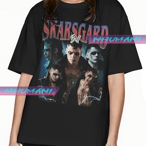 May include: Black t-shirt with a vintage-style graphic featuring a group of people with the text "Skarsgard Bill" above them.