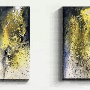 May include: Two abstract paintings in a vertical rectangular format. The artwork uses yellow, black, and white, with a textured, splattered effect. The paintings are mounted on a white wall.