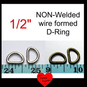 May include: A set of 1/2 inch non-welded wire formed D-rings in silver and antique brass finishes. The metal hardware is displayed alongside a measuring tape to show the size. The text reads 1/2 inch NON-Welded wire formed D-Ring.