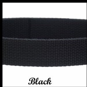 May include: A solid black woven fabric strap with a distinct textured surface. The material appears to be a durable webbing, featuring a consistent tight weave pattern throughout the entire length of the band. The word Black is printed below.