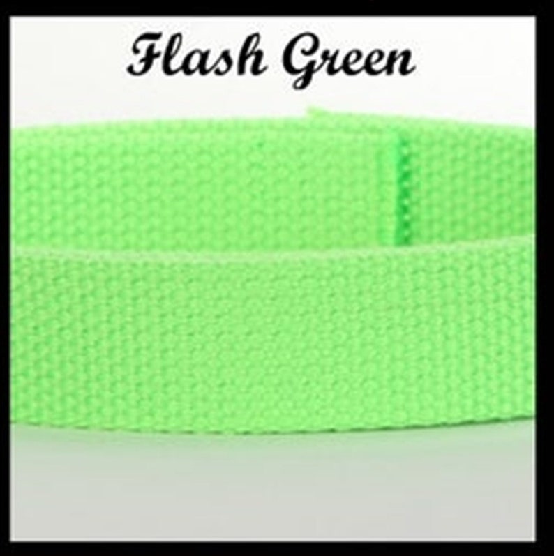 May include: A bright neon green woven fabric strap with a visible textured grid pattern. The text Flash Green is printed in a black serif font above the strap. The material appears to be a sturdy webbing, showing a consistent color throughout.