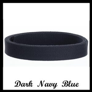 May include: A dark navy blue belt made of a woven fabric material. The belt is coiled into a circular shape, displaying a consistent textured pattern across its entire surface. The text "Dark Navy Blue" is printed in black below the belt.