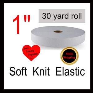 May include: A white roll of soft knit elastic measuring 1 inch in width and 30 yards in length. The image includes the text 1 inch, 30 yard roll, and Soft Knit Elastic, along with a red heart graphic and a gold circular badge.