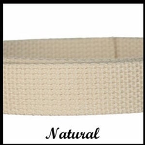 May include: A beige woven fabric strap with a distinct grid-like texture. The material is a light, neutral tan color, featuring a consistent, tight weave pattern throughout the length of the band. The word Natural is printed below the strap.