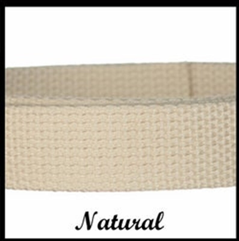 May include: A beige woven fabric strap with a distinct grid-like texture. The material is a light, neutral tan color, featuring a consistent, tight weave pattern throughout the length of the band. The word Natural is printed below the strap.