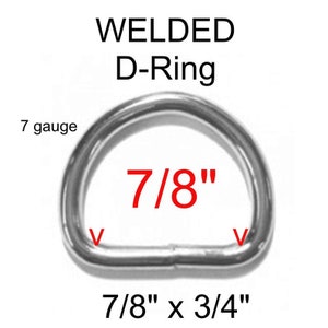 May include: A silver-colored metal D-ring with a welded seam. The text WELDED D-Ring is above the object, with 7 gauge, 7/8 inch, and 7/8 inch by 3/4 inch dimensions printed in red and black text on and around the hardware component.