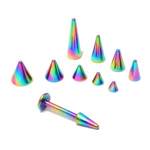 Puede incluir: Colección de joyas corporales con forma de cono de color arcoíris, que incluye un labret y varios picos de diferentes tamaños. Las joyas tienen un brillo metálico y reflejan un espectro de colores.
