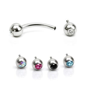May include: Belly button rings in silver, featuring a curved bar and spherical ends. Some balls have clear or coloured gemstones, while others have a plain, polished finish. Metric measurements.