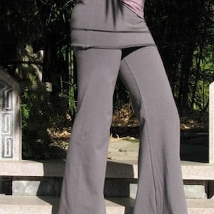 May include: Grey wide-leg trousers with a layered skirt detail. The trousers are made from a soft, comfortable fabric and have a relaxed fit.