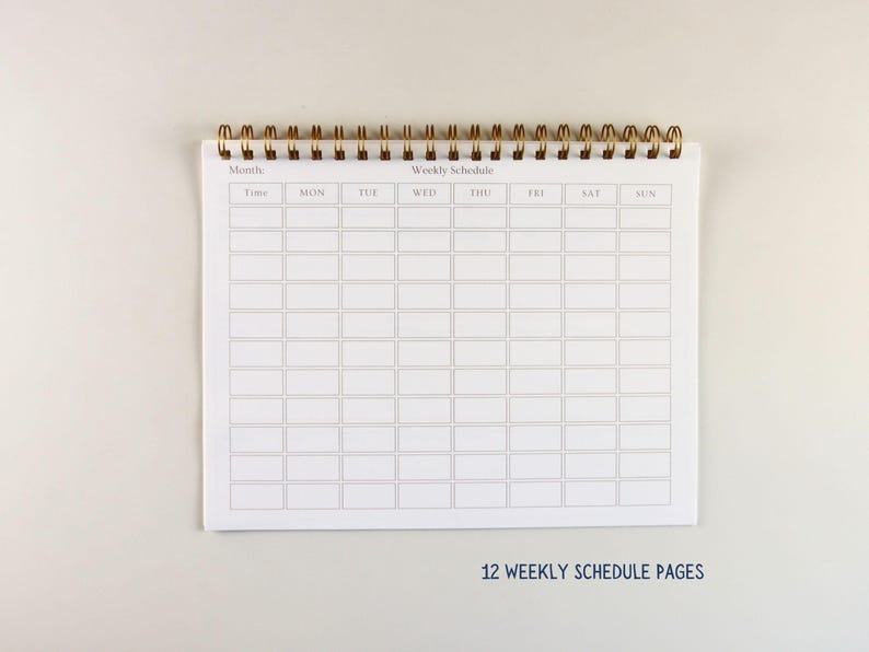 May include: A white weekly schedule notepad with a gold spiral binding. The notepad is open, displaying a grid layout for time slots and days of the week. The text "12 WEEKLY SCHEDULE PAGES" is printed at the bottom.