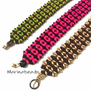 May include: Three beaded bracelets in different colour combinations. The first bracelet is green and brown, the second is pink and black, and the third is gold and brown. Each bracelet has a unique pattern and is made with small beads.
