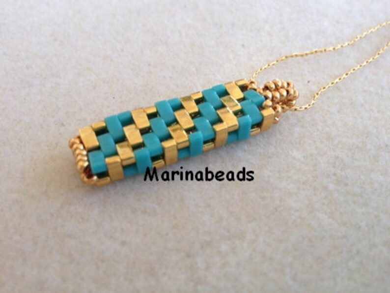 May include: A gold chain necklace with a turquoise and gold beaded pendant. The pendant is a woven design with a rectangular shape.