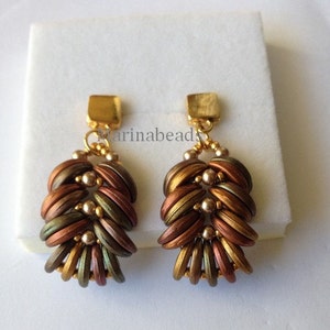 May include: A pair of gold dangle earrings with a layered design of brown, green, and gold beads. The earrings are made with small, round beads that are woven together to create a unique and intricate pattern.