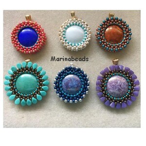 May include: Six round beaded pendants with different coloured stones in the centre. The pendants are all gold-toned and have a beaded design around the stone. The stones are turquoise, blue, white, purple, orange, and a mottled blue.
