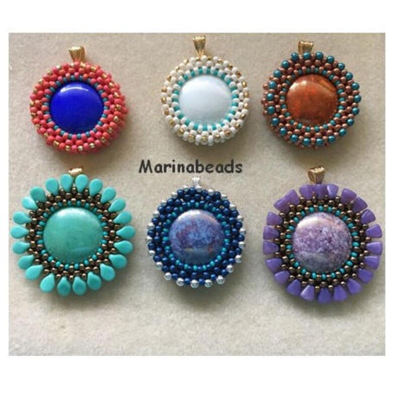 May include: Six round beaded pendants with different coloured stones in the centre. The pendants are all gold-toned and have a beaded design around the stone. The stones are turquoise, blue, white, purple, orange, and a mottled blue.