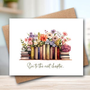 May include: A white greeting card featuring a watercolor illustration of a row of books topped with a vibrant bouquet of colorful flowers. The text "On to the next chapter..." is printed in a dark green script font below the books.