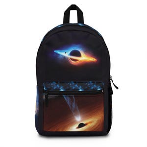 May include: Black backpack with a colorful space-themed design featuring a black hole and a galaxy. The front pocket has a zipper.