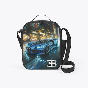 May include: A black lunch bag with a shoulder strap and a top handle. The bag features a vibrant image of a blue sports car speeding through a city at night. The car's headlights and the city lights create a dynamic, illuminated scene. The Bugatti logo is visible.