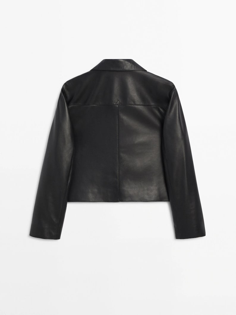 May include: A black leather jacket with a collared neckline and long sleeves.