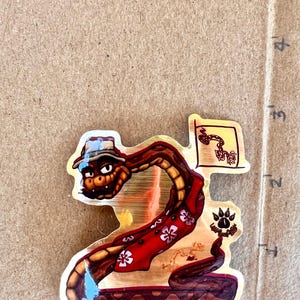 2025 Mr. Snake The Bad Guys - 3” Gold Sticker