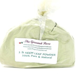 May include: A clear plastic bag filled with light green neem leaf powder. A white label displays the text "1 lb NEEM LEAF POWDER 100% Pure & Natural" and the brand name "The Gourmet Rose".