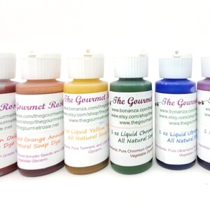 May include: Six small bottles of liquid soap dye in various colors, including red, orange, yellow, green, blue, and purple. Each bottle has a white cap and a label with product information and the brand name "The Gourmet".