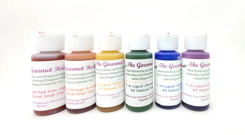 May include: Six small bottles of liquid soap dye in various colors, including red, orange, yellow, green, blue, and purple. Each bottle has a white cap and a label with product information and the brand name "The Gourmet".