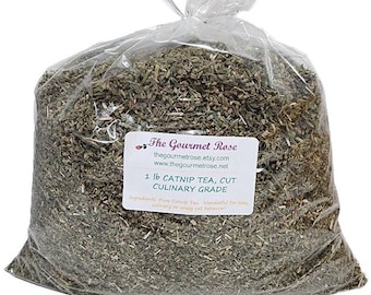 May include: A clear plastic bag filled with dried catnip tea. The bag has a label that reads "The Gourmet Rose" and "1 lb CATNIP TEA, CUT CULINARY GRADE". The catnip is a mix of green and brown, and the bag is tied at the top.