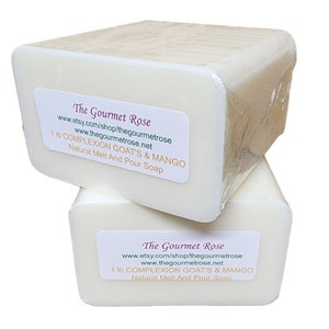 May include: Two rectangular bars of natural melt and pour soap, each weighing 1 lb, are stacked. The soap is white and wrapped in clear plastic. Each bar has a label that reads "The Gourmet Rose" and lists the soap's ingredients.