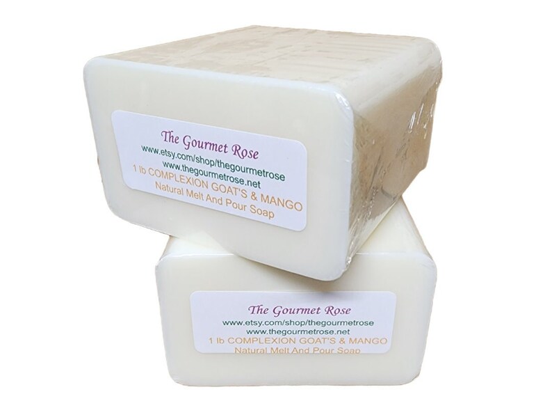 May include: Two rectangular bars of natural melt and pour soap, each weighing 1 lb, are stacked. The soap is white and wrapped in clear plastic. Each bar has a label that reads "The Gourmet Rose" and lists the soap's ingredients.