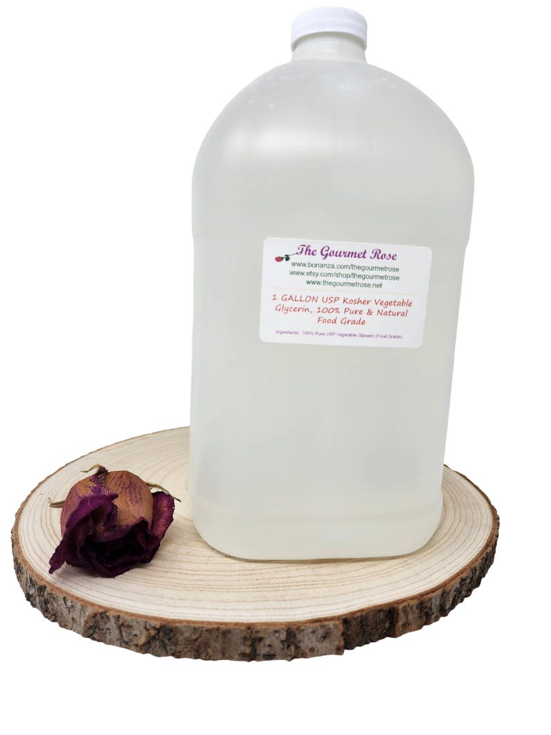 May include: A clear, one-gallon plastic jug of USP Kosher Vegetable Glycerin, with a white cap and a label from "The Gourmet Rose." The jug sits on a wooden slice with a dried rose. The label states the product is 100% pure and natural, food grade.