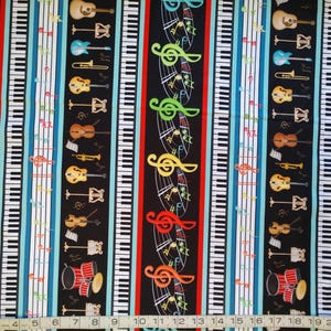 Music, musical instruments and music notes in rows on black cotton quilt fabric