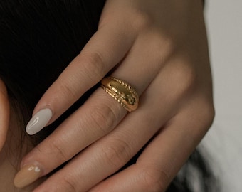 May include: A gold hoop earring with a twisted rope texture, a gold ring featuring a central twisted rope band, and a layered gold necklace set consisting of a thick curb chain and a thinner, flat snake chain.