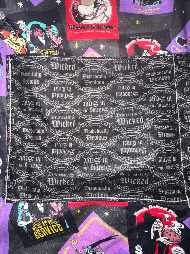 May include: A black and purple fabric with various villain-themed patches and a pocket. The pocket features a repeating pattern with the words "Wicked" and "Diabolically Devious". Other patches include text like "Driving Academy" and "We're at your service".