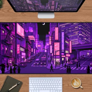 May include: A rectangular desk mat featuring a vibrant purple and pink illustration of a bustling city street at night. The scene includes tall buildings with glowing neon signs, cars on the road, pedestrians on the sidewalk, and a crescent moon.