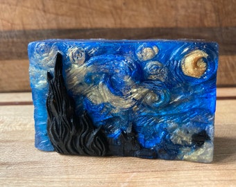 May include: A blue and gold soap bar with a swirling design reminiscent of Vincent van Gogh's "Starry Night".