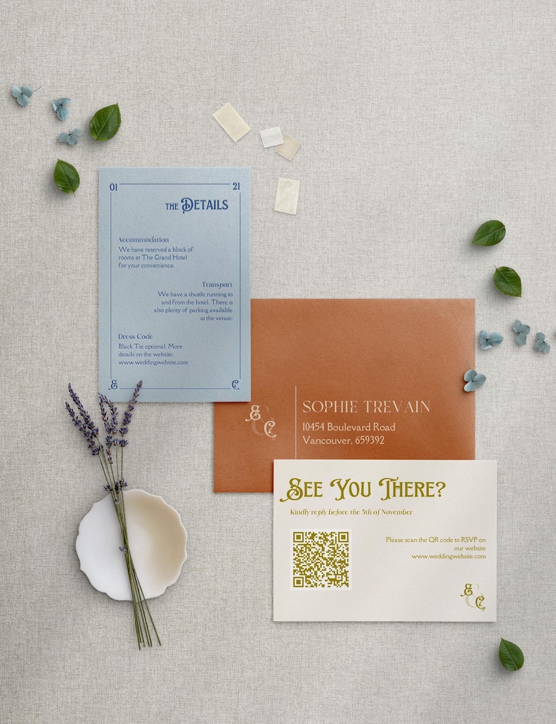 May include: A white card with gold text that says "See You There?" and a QR code. The card also includes the text "Kindly RSVP before the 5th of November" and "Please scan the QR code to RSVP on our website: www.weddingwebsite.com".