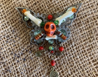 Steampunk butterfly assemblage art brooch orange skull