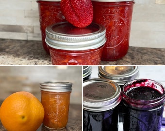 Single Jars of Strawberry jam, blueberry jam and orange marmalade