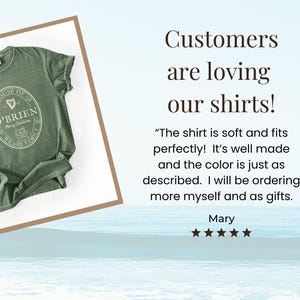 May include: Green t-shirt with a crew neck and rolled sleeves. The shirt features an oval design with the text "HOUSE OF O'BRIEN" and "WE ARE FAMILY". The shirt is displayed on a white background.