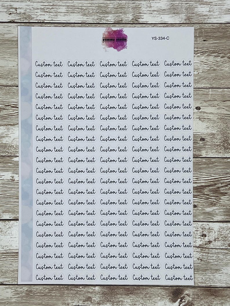 May include: A sheet of clear stickers with the text "Custom text" repeated multiple times in a handwritten font. The stickers are arranged in a grid pattern on a light blue background.