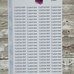 May include: A sheet of white paper with 24 white oval stickers. Each sticker has the text "CUSTOM TEXT" printed in black, followed by the words "Custom text" in a smaller font.