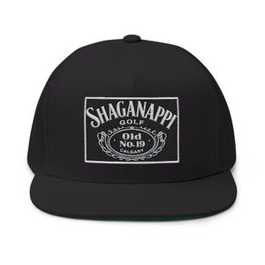 May include: Black flat-brimmed baseball cap with a green underbill. The cap features a white embroidered patch with the words "Shaganappi Golf" and "Old No. 19 Calgary" in a decorative design. A stylish accessory for golf enthusiasts.
