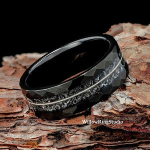 May include: Black tungsten carbide ring with a silver inlay design. The ring has a faceted, hexagonal pattern.