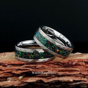 May include: Two silver-toned rings with a faceted, hammered exterior finish. Each ring features a central inlay of crushed, iridescent dark green, blue, and orange opal-like material. The text WillowRingStudio is visible at the bottom.