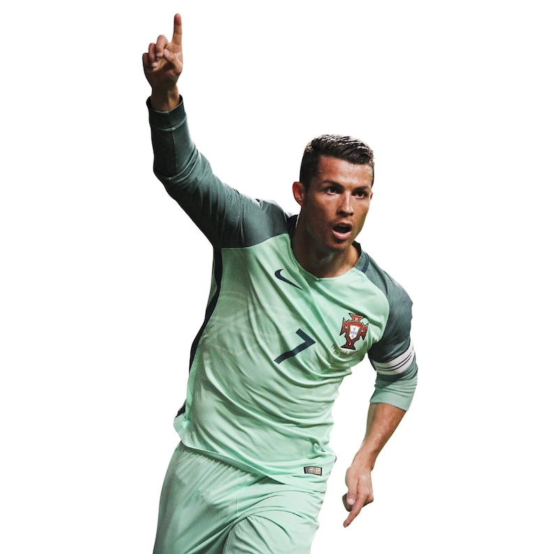 May include: A soccer player wearing a green and white jersey with the number 7 and the Portuguese flag on the chest. He is raising his right arm in the air with his index finger pointing up.