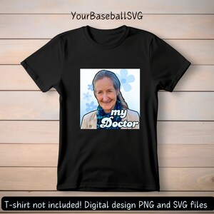 May include: Black t-shirt featuring a square graphic with a smiling woman, blue flowers, and the text "my Doctor." The design includes a light blue and white color scheme. The text "YourBaseballSVG" is at the top.